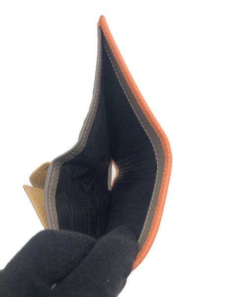 IACUCCI（イアクッチ）IACUCCI (イアクッチ) 2つ折り財布 オレンジの古着・服飾アイテム