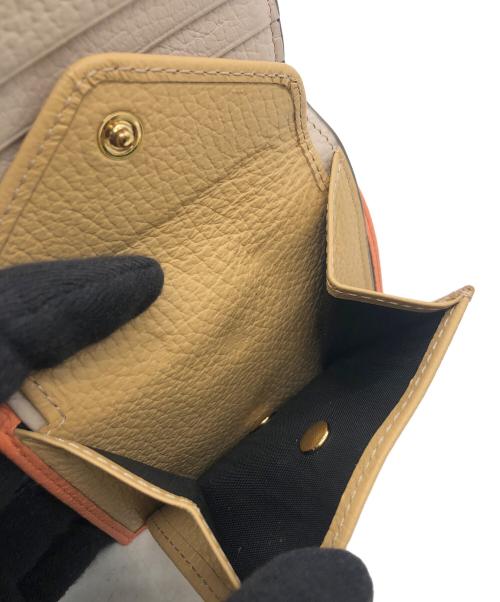 IACUCCI（イアクッチ）IACUCCI (イアクッチ) 2つ折り財布 オレンジの古着・服飾アイテム