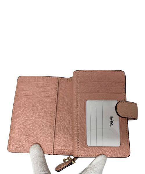 COACH（コーチ）COACH (コーチ) COACH 2つ折り財布 ピンクの古着・服飾アイテム