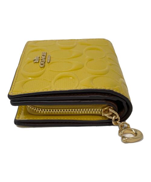 COACH（コーチ）COACH (コーチ) 2つ折り財布 マスタードの古着・服飾アイテム