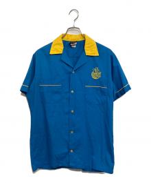 comedy central×Hilton（コメディセントラル×ヒルトン）の古着「半袖シャツ」｜ブルー×イエロー