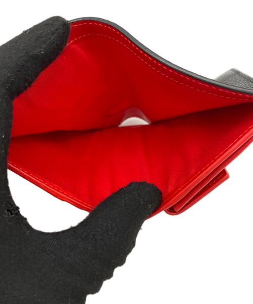 Christian Louboutin（クリスチャン・ルブタン）Christian Louboutin (クリスチャン・ルブタン) スタッズモチーフ二つ折り財布 ブラックの古着・服飾アイテム