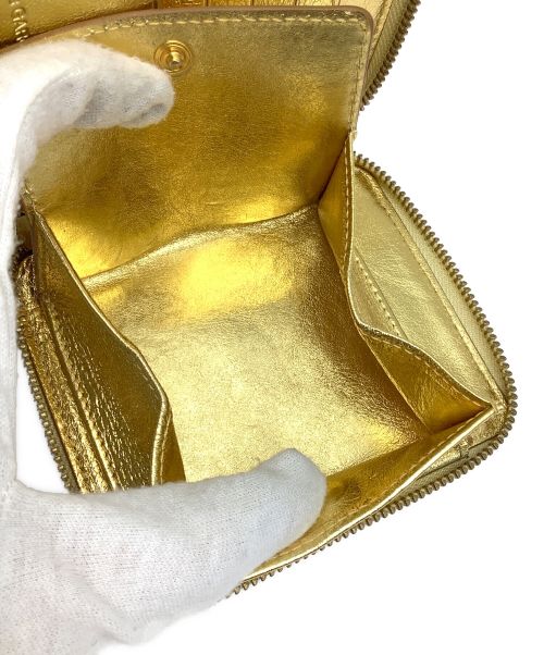 COMME des GARCONS（コムデギャルソン）COMME des GARCONS (コムデギャルソン) 2つ折り財布 ゴールドの古着・服飾アイテム