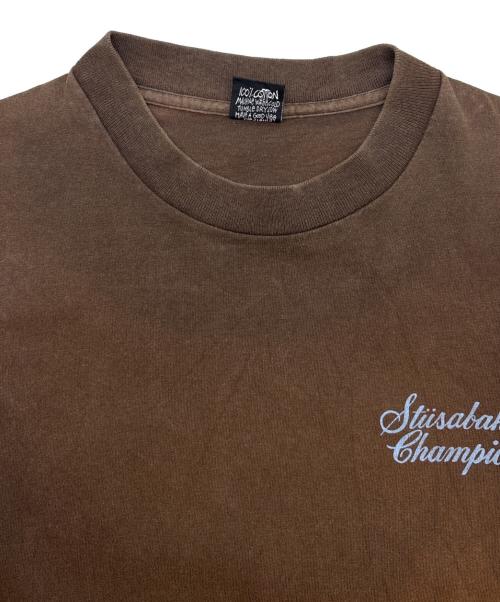 stussy（ステューシー）stussy (ステューシー) stussy　Studebaker Champion　半袖Tシャツ ブラウン サイズ:Mの古着・服飾アイテム