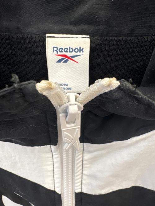 REEBOK（リーボック）REEBOK (リーボック) THE BLACK EYE PATCH (ブラックアイパッチ) REEBOK × THE BLACK EYE PATCH　ジャケット ブラック×ホワイト サイズ:Oの古着・服飾アイテム