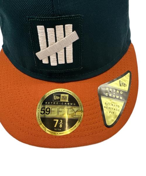 New Era（ニューエラ）New Era (ニューエラ) UNDEFEATED (アンディフィーテッド) New Era　UNDEFEATED　59FIFTY　キャップ グリーン×オレンジ 未使用品の古着・服飾アイテム
