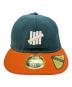 New Era（ニューエラ）の古着「New Era　UNDEFEATED　59FIFTY　キャップ」｜グリーン×オレンジ