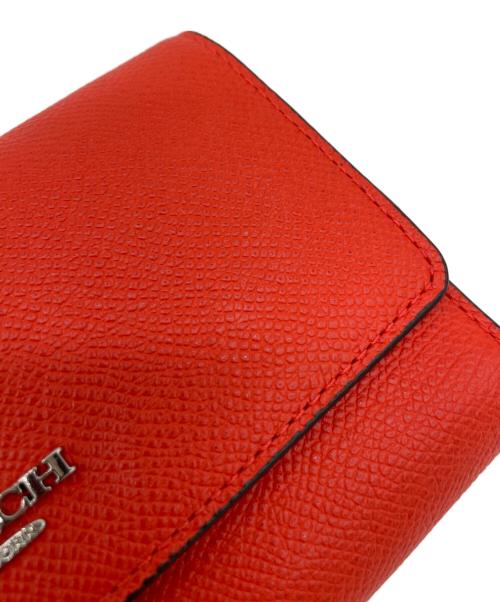 COACH（コーチ）COACH (コーチ) 三つ折り財布 オレンジの古着・服飾アイテム