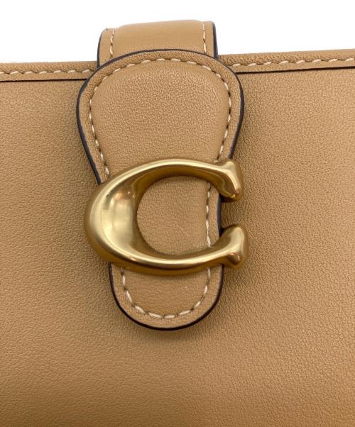 COACH（コーチ）COACH (コーチ) 2つ折り財布 ベージュの古着・服飾アイテム