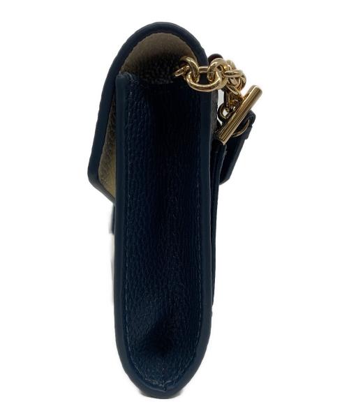 COLE HAAN（コールハーン）COLE HAAN (コールハーン) オーバーサイズクロージャーフォンケース ブラウン×ネイビーの古着・服飾アイテム