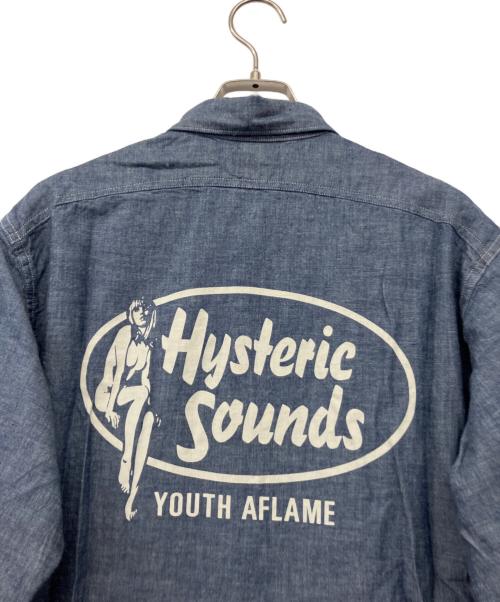 Hysteric Glamour（ヒステリックグラマー）Hysteric Glamour (ヒステリックグラマー) BIG YANK (ビッグヤンク) HYS SOUNDS プリント 長袖 シャンブレー ワーク シャツ インディゴ サイズ:M 未使用品の古着・服飾アイテム