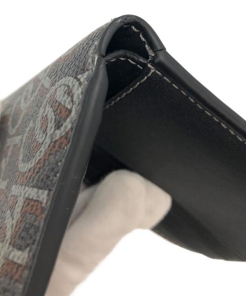 COACH（コーチ）COACH (コーチ) シグネチャーモノグラムプリント　2つ折り財布 ブラック×ブラウンの古着・服飾アイテム