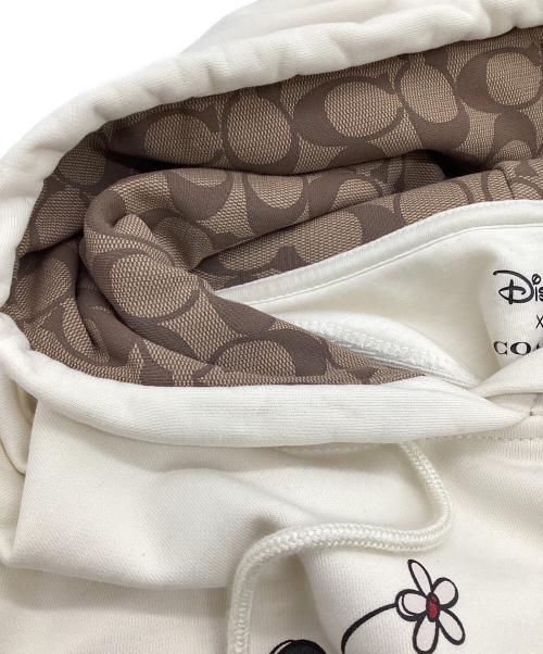 COACH（コーチ）COACH (コーチ) DISNEY (ディズニー) アイス スケート モチーフ フーディー ベージュ サイズ:Lの古着・服飾アイテム