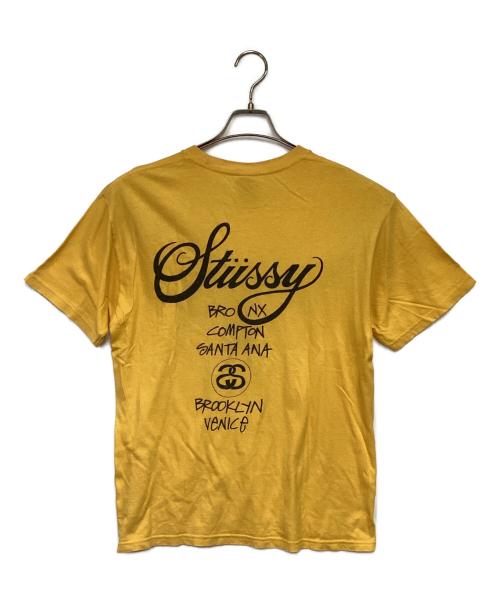 stussy（ステューシー）stussy (ステューシー) WORLD TOUR（ワールドツアー）Tシャツ イエロー サイズ:Mの古着・服飾アイテム