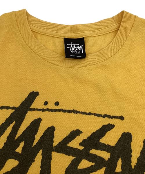 stussy（ステューシー）stussy (ステューシー) WORLD TOUR（ワールドツアー）Tシャツ イエロー サイズ:Mの古着・服飾アイテム