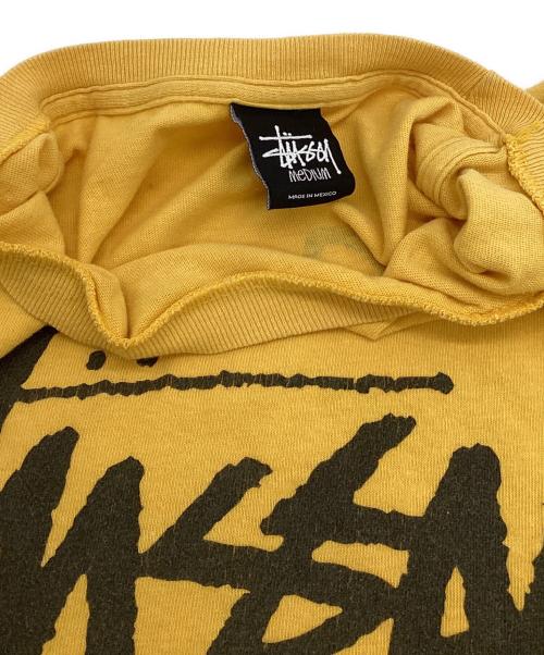 stussy（ステューシー）stussy (ステューシー) WORLD TOUR（ワールドツアー）Tシャツ イエロー サイズ:Mの古着・服飾アイテム