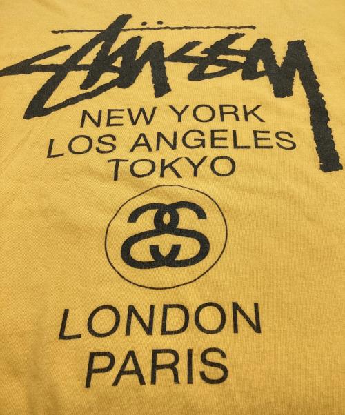 stussy（ステューシー）stussy (ステューシー) WORLD TOUR（ワールドツアー）Tシャツ イエロー サイズ:Mの古着・服飾アイテム