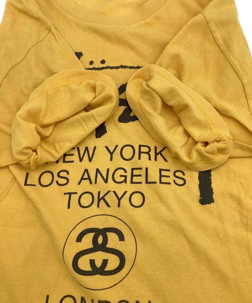 stussy（ステューシー）stussy (ステューシー) WORLD TOUR（ワールドツアー）Tシャツ イエロー サイズ:Mの古着・服飾アイテム