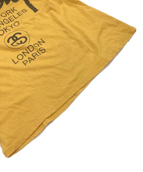 stussy（ステューシー）stussy (ステューシー) WORLD TOUR（ワールドツアー）Tシャツ イエロー サイズ:Mの古着・服飾アイテム