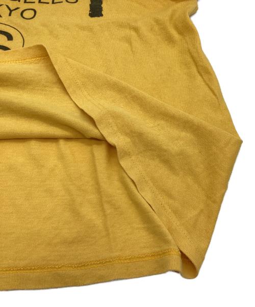 stussy（ステューシー）stussy (ステューシー) WORLD TOUR（ワールドツアー）Tシャツ イエロー サイズ:Mの古着・服飾アイテム