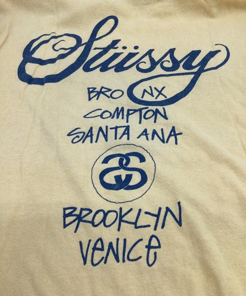 stussy（ステューシー）stussy (ステューシー) WORLD TOUR（ワールドツアー）Tシャツ イエロー サイズ:Mの古着・服飾アイテム