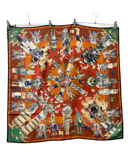 HERMES（エルメス）HERMES (エルメス) 大判スカーフ Kachinas カレ90 ブラウン×オレンジの古着・服飾アイテム