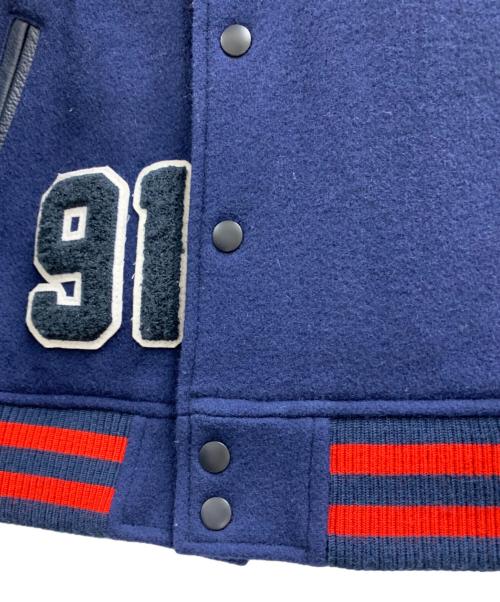 X-LARGE（エクストララージ）X-LARGE (エクストララージ) X-LARGE（エクストララージ）スタジャン ブルー×レッド サイズ:Mの古着・服飾アイテム