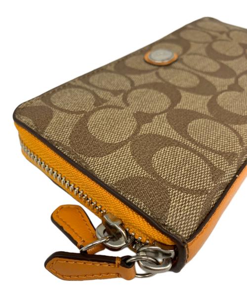 COACH（コーチ）COACH (コーチ) COACH　ラウンドファスナー財布 ベージュ×オレンジの古着・服飾アイテム