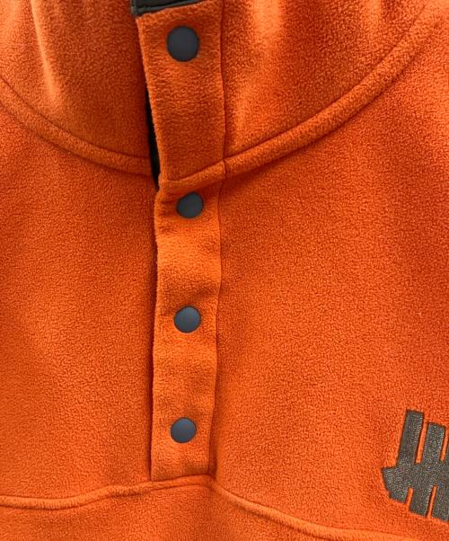 Champion（チャンピオン）Champion (チャンピオン) UNDEFEATED (アンディフィーテッド) POLARTEC SNAP JACKET オレンジ サイズ:Mの古着・服飾アイテム
