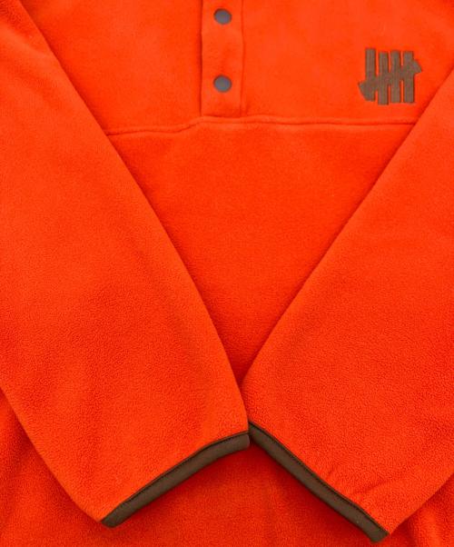 Champion（チャンピオン）Champion (チャンピオン) UNDEFEATED (アンディフィーテッド) POLARTEC SNAP JACKET オレンジ サイズ:Mの古着・服飾アイテム