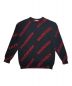 BALENCIAGA（バレンシアガ）の古着「総柄BALENCIAGAスラッシュロゴ付クルーネックニット」｜ブラック×レッド