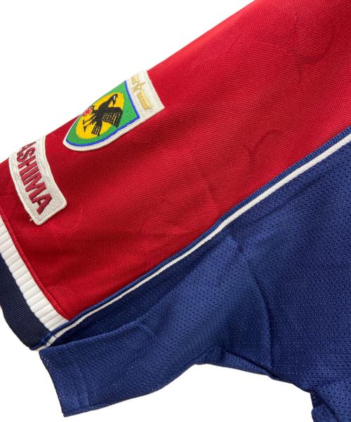 TOSTEM（トステム）TOSTEM (トステム) 鹿島アントラーズ　サッカーユニフォーム ボルドー×ネイビー サイズ:ｌの古着・服飾アイテム