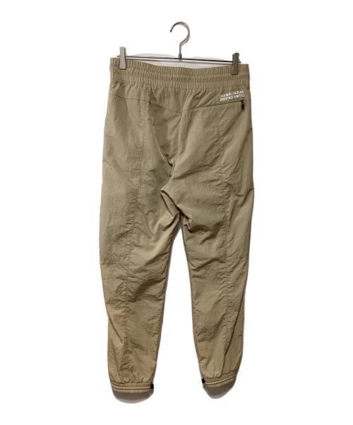 Calvin Klein Jeans（カルバンクラインジーンズ）Calvin Klein Jeans (カルバンクラインジーンズ) ナイロンパンツ ベージュ サイズ:Sの古着・服飾アイテム