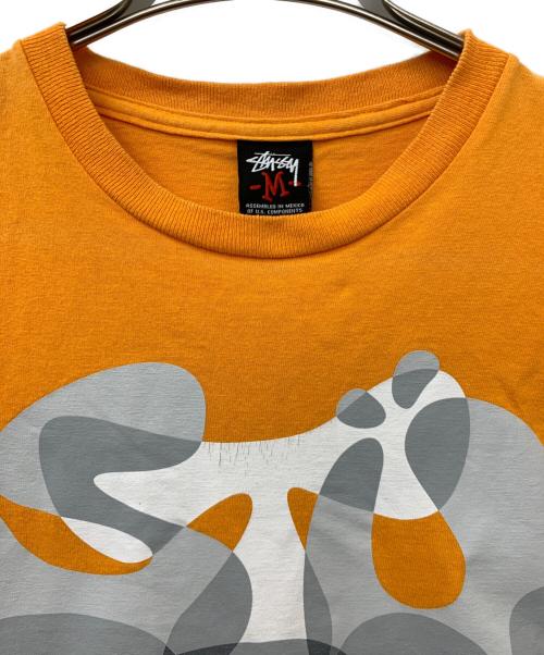 stussy（ステューシー）stussy (ステューシー) プリントTシャツ オレンジ サイズ:Mの古着・服飾アイテム
