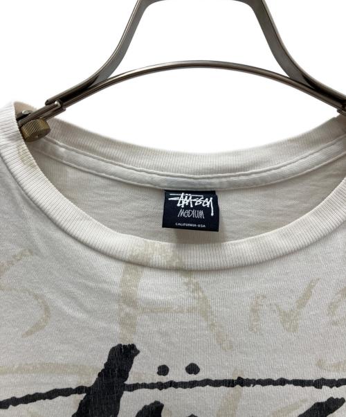stussy（ステューシー）stussy (ステューシー) 00'sワールドツアーカットソー アイボリー サイズ:Ｍの古着・服飾アイテム