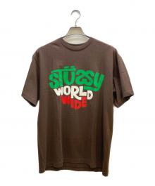 stussy（ステューシー）の古着「WORLD WIDE プリントTシャツ」｜ブラウン