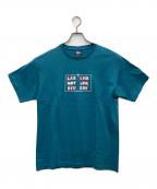 stussyステューシー）の古着「プリントTシャツ エアポートコード」｜ブルー