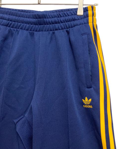 adidas（アディダス）adidas (アディダス) アディカラー クラシックス オーバーサイズ SST トラックパンツ ネイビー×イエロー サイズ:KR S / J Mの古着・服飾アイテム