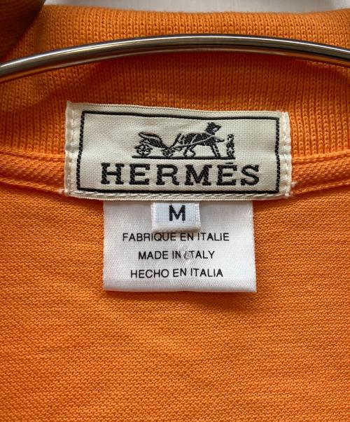HERMES（エルメス）HERMES (エルメス) ポロシャツ/Hロゴシャツ オレンジ サイズ:Mの古着・服飾アイテム