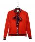 GUCCI（グッチ）の古着「シェリーリボンパールボタンカーディガン」｜オレンジ