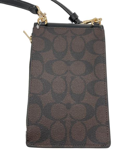 COACH（コーチ）COACH (コーチ) ノース／サウス フォーン クロスボディ・シグネチャー キャンバス ダークブラウン 未使用品の古着・服飾アイテム