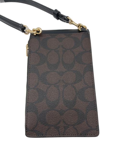 COACH（コーチ）COACH (コーチ) ノース／サウス フォーン クロスボディ・シグネチャー キャンバス ダークブラウン 未使用品の古着・服飾アイテム