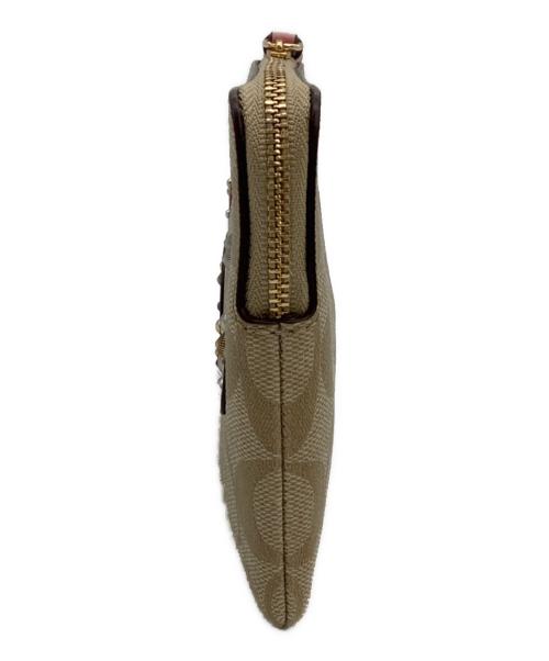 COACH（コーチ）COACH (コーチ) DISNEY (ディズニー) シンデレラパッチラージリストレットポーチ ベージュの古着・服飾アイテム