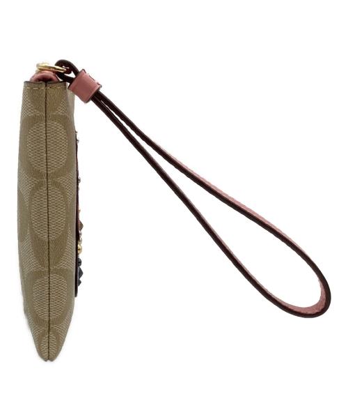 COACH（コーチ）COACH (コーチ) DISNEY (ディズニー) シンデレラパッチラージリストレットポーチ ベージュの古着・服飾アイテム