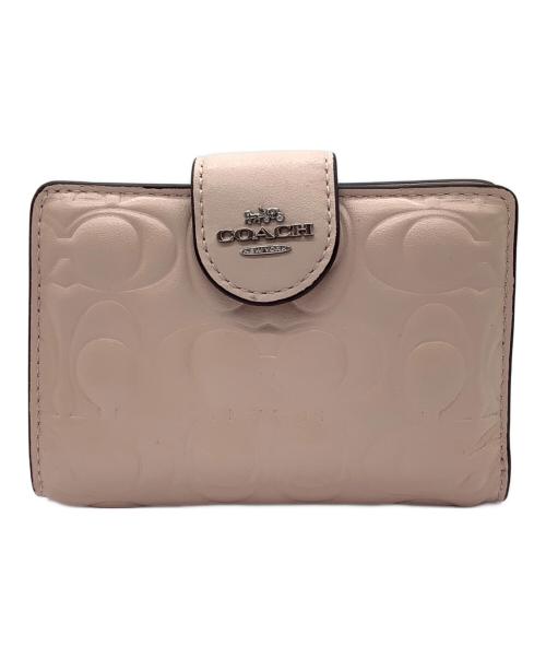 COACH（コーチ）COACH (コーチ) エンボスシグネチャー 2つ折り財布 ピンクの古着・服飾アイテム