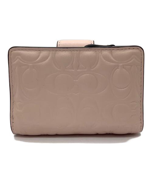 COACH（コーチ）COACH (コーチ) エンボスシグネチャー 2つ折り財布 ピンクの古着・服飾アイテム