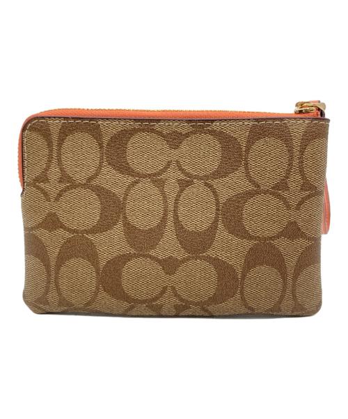 COACH（コーチ）COACH (コーチ) ハンドポーチ オレンジ×ベージュの古着・服飾アイテム