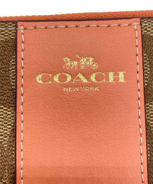 COACH（コーチ）COACH (コーチ) ハンドポーチ オレンジ×ベージュの古着・服飾アイテム
