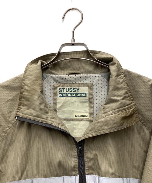stussy（ステューシー）stussy (ステューシー) ナイロントラックジャケット ベージュ×ネイビー サイズ:SIZE Mの古着・服飾アイテム