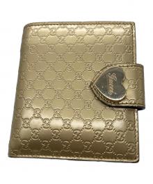 GUCCI（グッチ）の古着「2つ折り財布　GUCCI　ゴールド　GG総柄　ハートプレート」｜ゴールド